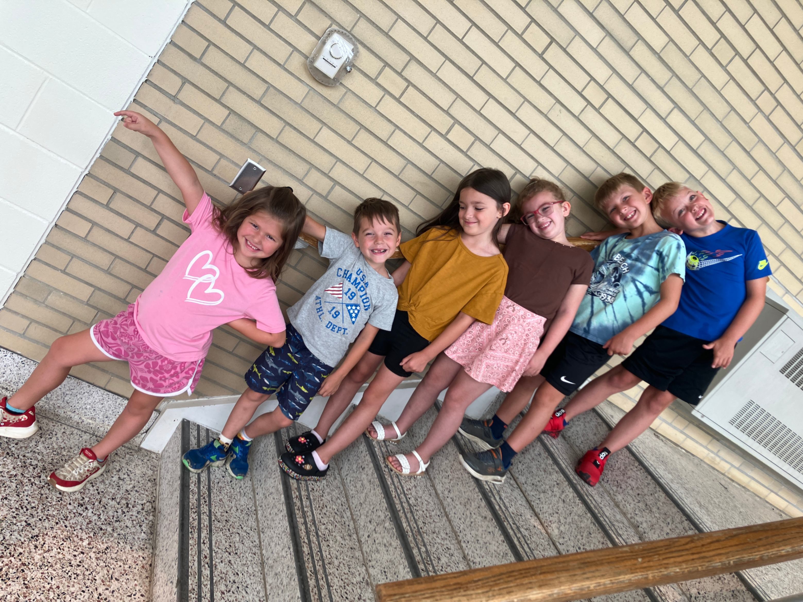 Six students pose for a photo while standing on a set of stairs at Hickory Grove.